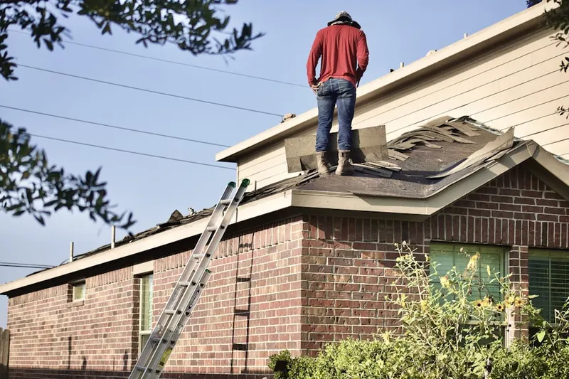 Professional roofer working on a residential roof in Red Oak